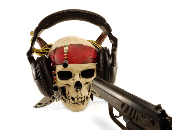 Skull in ear-phones with the weapon — Stock Photo, Image