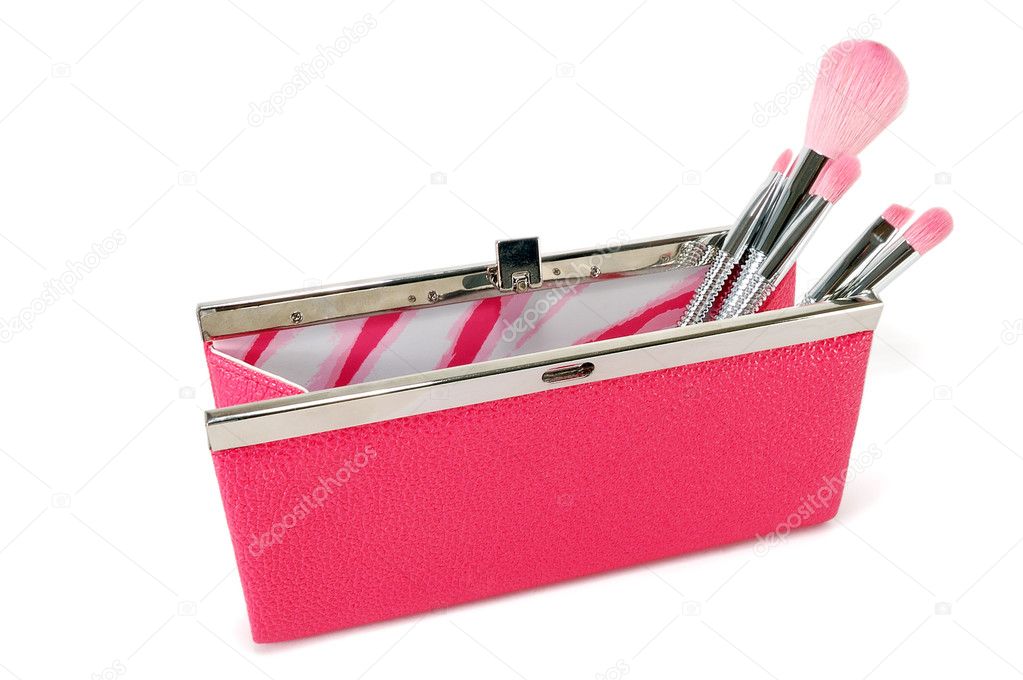 Open handbag with cosmetic brushes