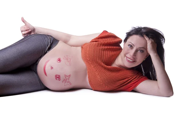 En gravid kvinna ligger — Stockfoto