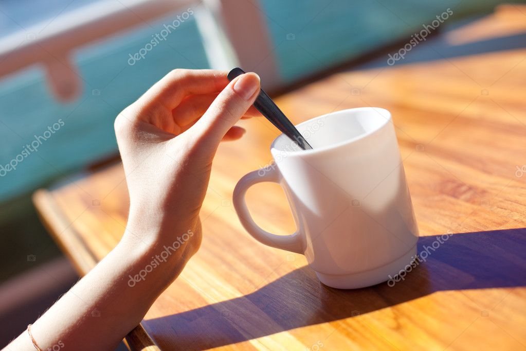 Young woman stir tea in cup Stock Photo by ©chaoss 5439328