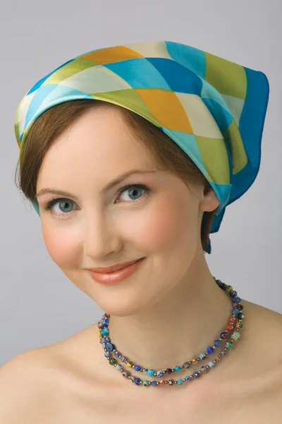 Portrait of the young girl in kerchief and beads — Stock Photo, Image