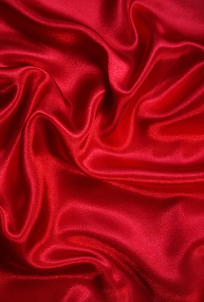 Гладкий элегантный красный шелк может использоваться в качестве фона — стоковое фото