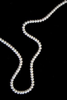 White pearls on the black silk clipart