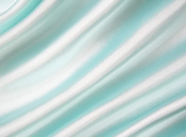 Гладкий элегантный синий шелк в качестве фона — стоковое фото