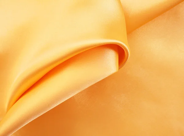 Soepele elegante gouden zijde als achtergrond — Stockfoto