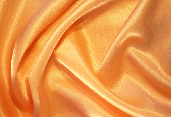 Hladké elegantní zlaté hedvábí pozadí — Stock fotografie