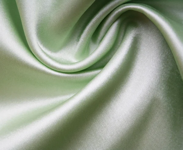 Sima, elegáns zöld selyem háttereként — Stock Fotó