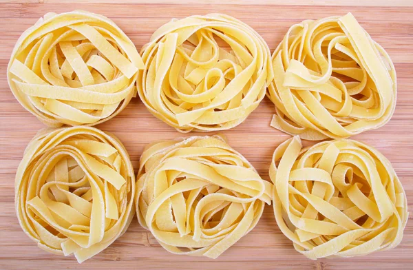 Tagliatelle on the wooden background — Stock Photo, Image