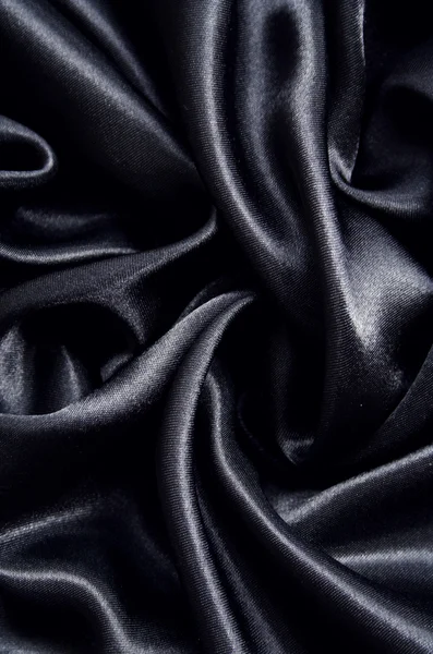 Hladké elegantní černé hedvábí jako pozadí — Stock fotografie