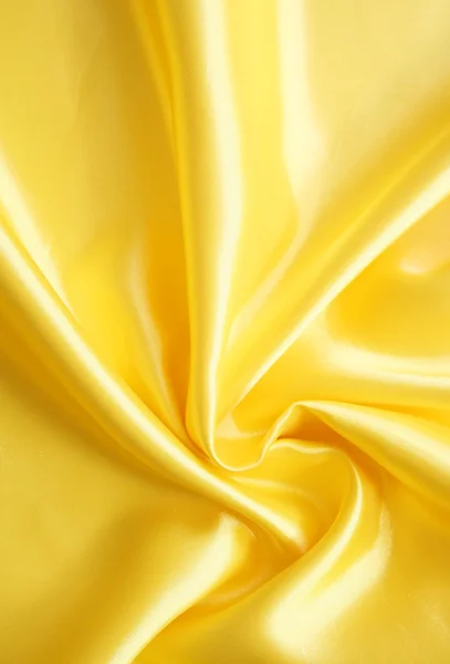 Glatte elegante goldene Seide kann als Hintergrund verwendet werden — Stockfoto
