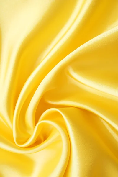 Gładki elegancki złoty jedwab może służyć jako tło — Zdjęcie stockowe