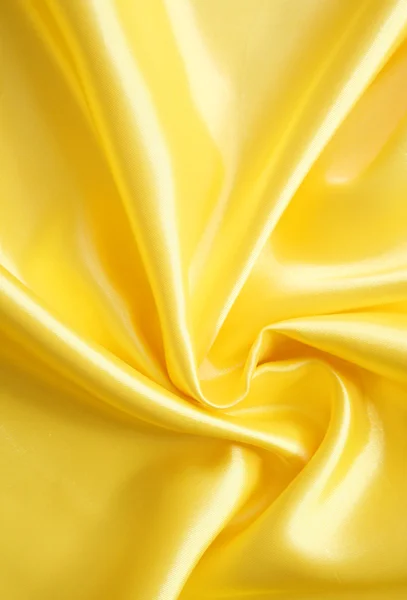 Гладкий элегантный золотой шелк может использоваться в качестве фона — стоковое фото