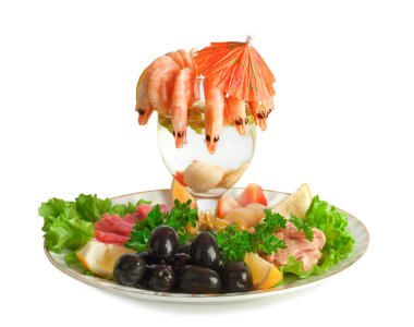 Appetizer of shrimp, fish, meats, olives and fresh vegetables clipart