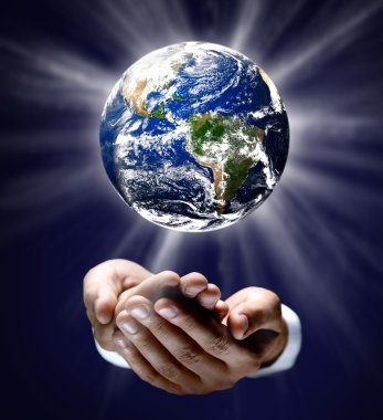 Man holding a glowing earth globe in his hands clipart