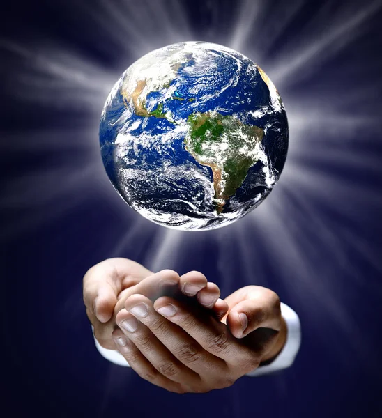Man holding a glowing earth globe in his hands — Stock Photo, Image