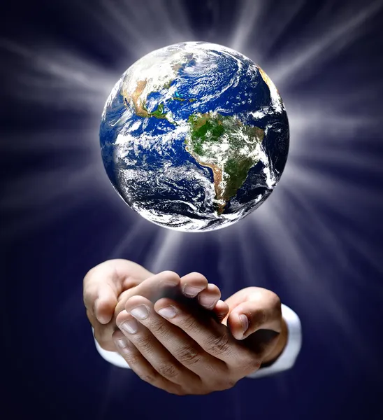 Man holding a glowing earth globe in his hands Royalty Free Stock Images