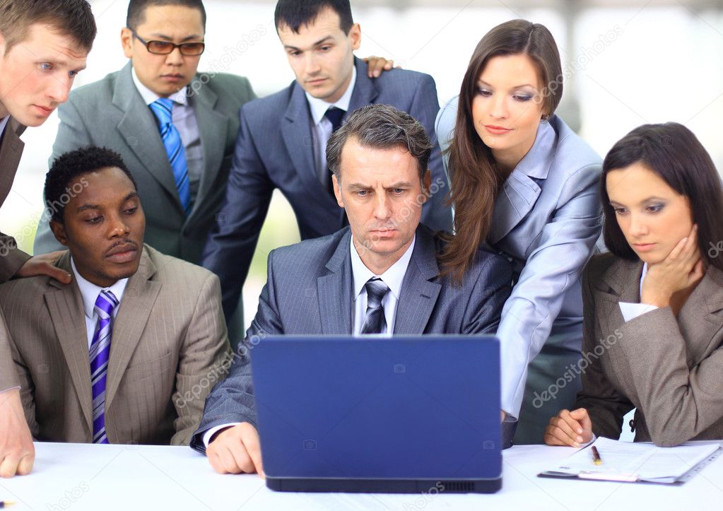 Interracial business team working at laptop in a modern office Stock Photo  by ©depositedhar 5387577