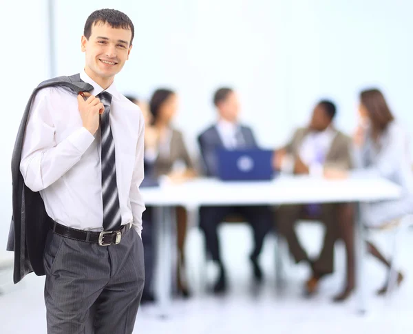 Business man at the office with a group behind him — Stock Photo, Image
