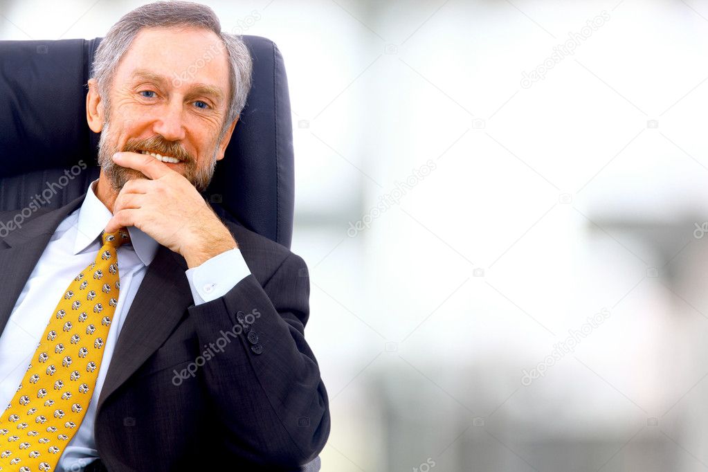 Business man seated on a chair