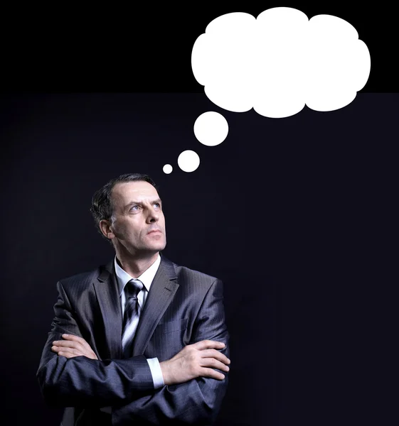 Businessman thinking with a thought bubble made of clouds — Stock Photo, Image