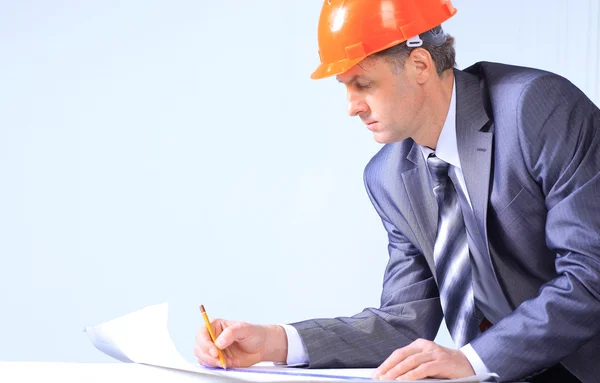 Site manager in the office with helmet Stock Photo