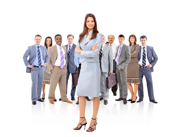 Happy young business woman standing in front of her team — Stock Photo, Image
