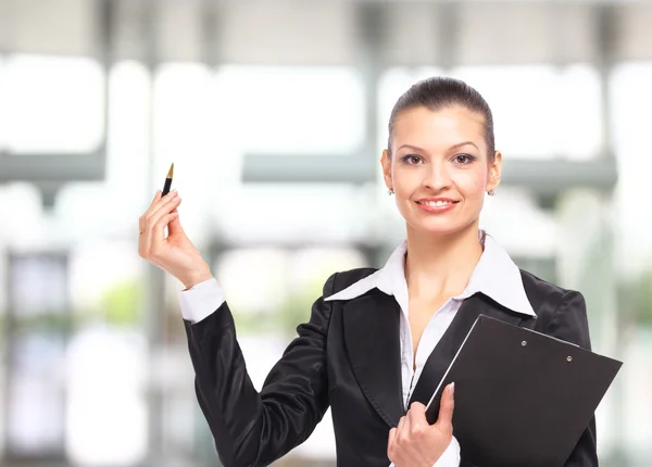 Geschäftsfrau zeigt mit Hand auf hellem Fleck — Stockfoto