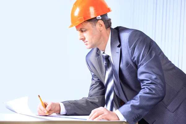 Site manager in the office with helmet Royalty Free Stock Photos