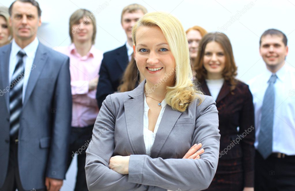 Beautiful blond businesswoman in front of her team