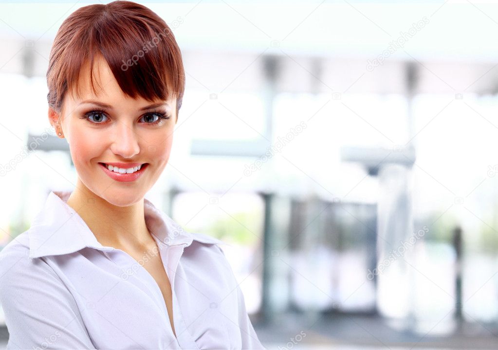 Positive business woman smiling over light background