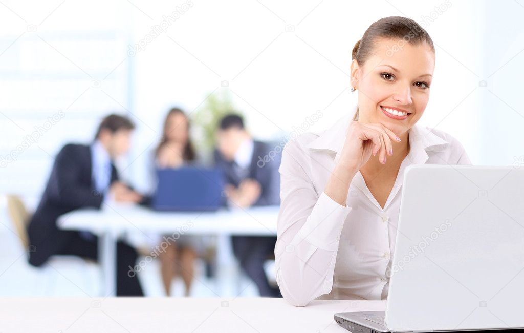 Portrait of a beautiful business woman working on her laptop in an office e