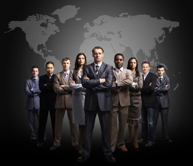 Businessmen standing in front of an earth map
