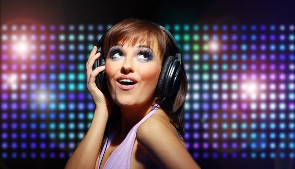 Portrait of a young dancing girl in headphones — Stock Photo, Image