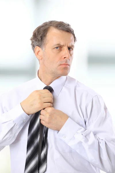 stock image Portrait of a businessman fixing necktie