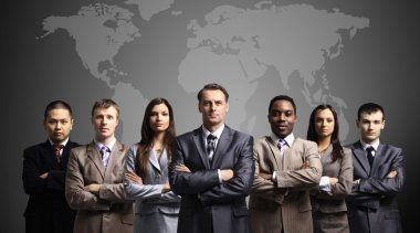 Businessmen standing in front of an earth map clipart