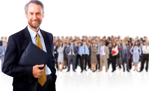 Smiling business man with colleagues in the background — Stock Photo, Image