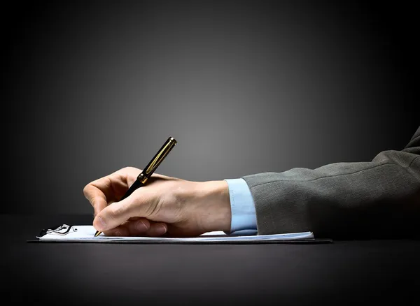 Businessman's hand with pen Stock Image