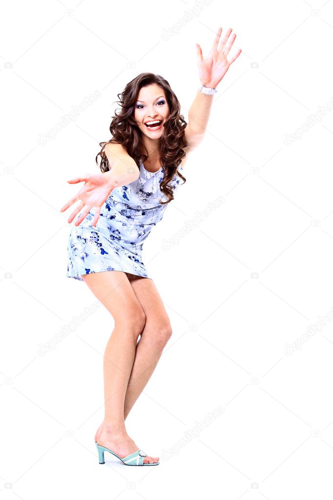 Full length portrait of happy excited girl jumping with arms extended . Ove