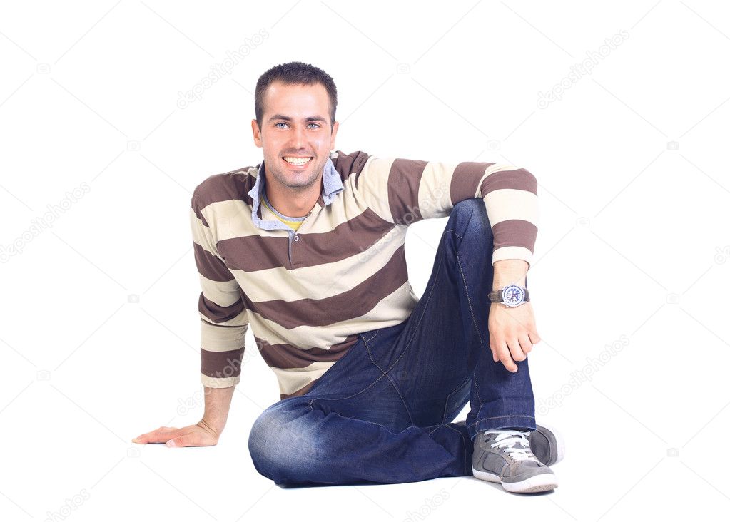 Portrait of a casual young satisfied man sitting relaxed. Isolated on white