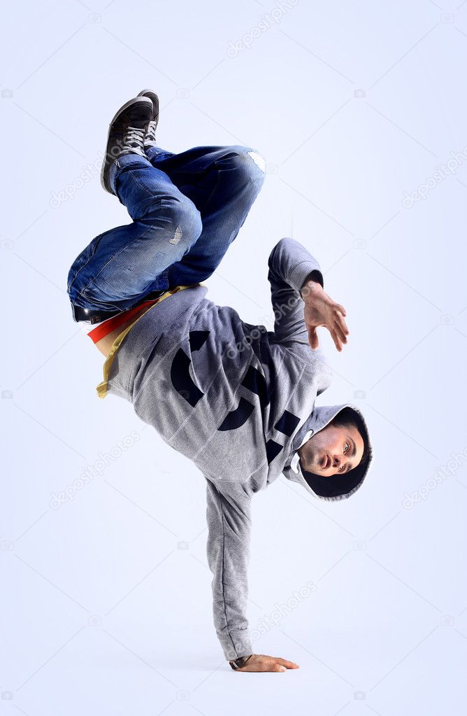 Young handsome fresh man breakdancing with stylish clothes.