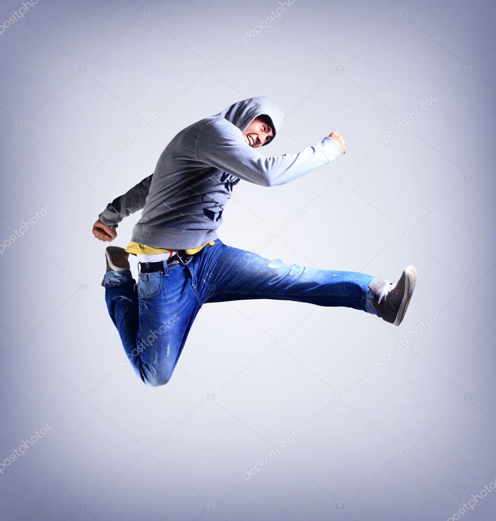 Awesome dancer is jumping very high on a white background