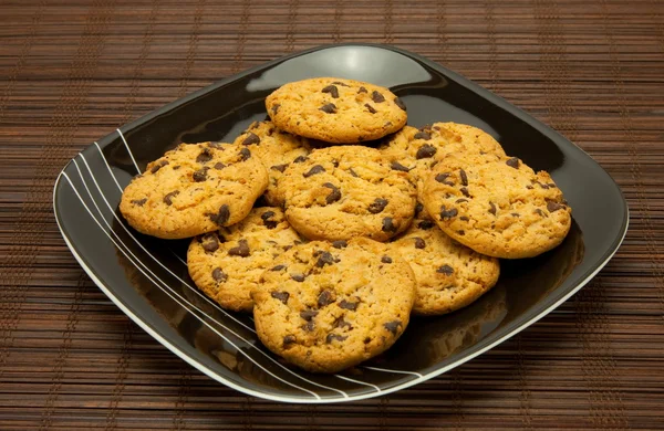 Plate of cookies on dark brown background — Stock Photo, Image