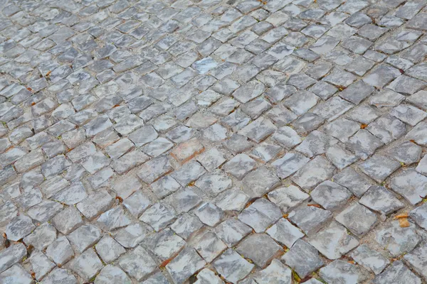 "Calcada ", calçada típica portuguesa, feita de pequenas pedras — Fotografia de Stock