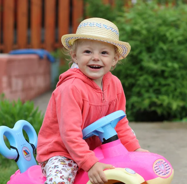 Маленькая девочка играет с автомобильной игрушкой — стоковое фото