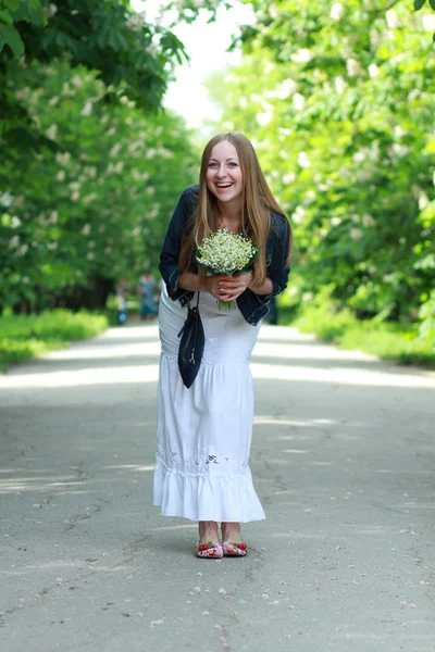 Portrait of beautiful blond with a bouquet of lilies of the valley — Stock Photo, Image