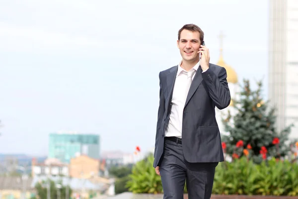 stock image Young man with mobile phone outdoors