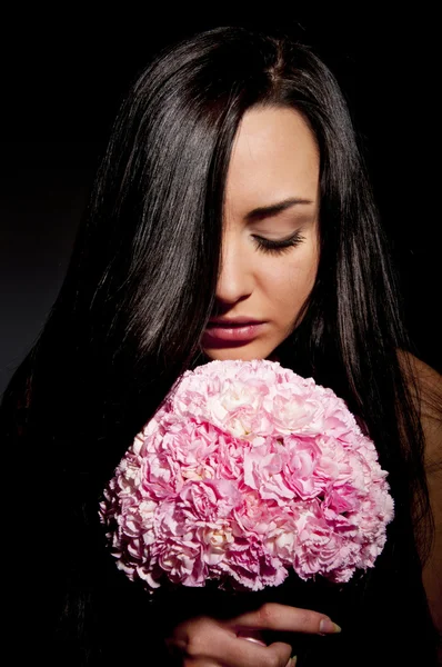 Beautiful girl with a bouquet of carnations — Stock Photo, Image