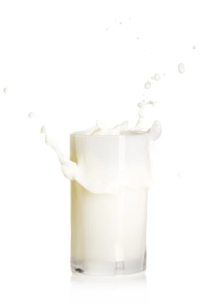 Splashing glass of milk — стоковое фото