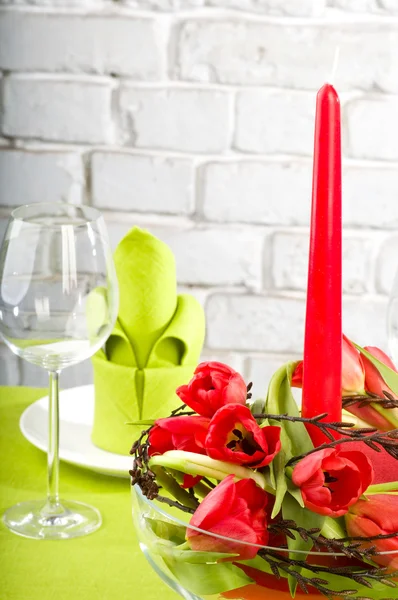 Composition with tulips, candle and glass — Stock Photo, Image