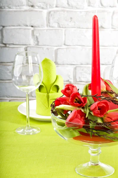 Composition with tulips, candle and glass — Stock Photo, Image